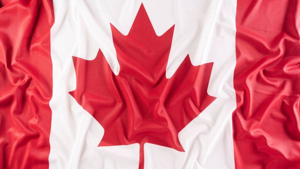 Una hermosa tela de tela de bandera nacional de Canadá, un signo o símbolo del concepto de día de Canadá. - Foto, imagen