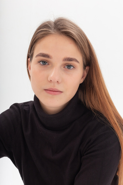 young caucasian pretty girl with long hair in black turtleneck at white studio - Foto, imagen