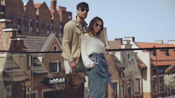 stylish couple in sunglasses posing outside  - Fotoğraf, Görsel