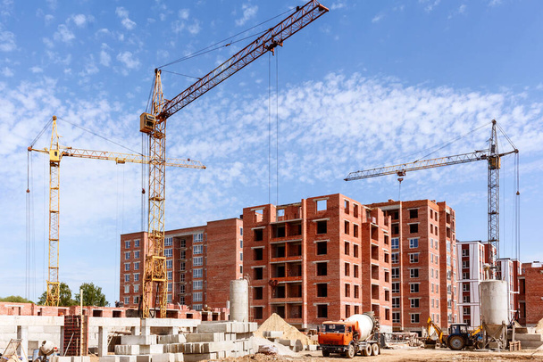 Betonirekka rakennustyömaalla. Rakennustyömaa rakennuslaitteet ja torninosturit taustalla sininen taivas - Valokuva, kuva