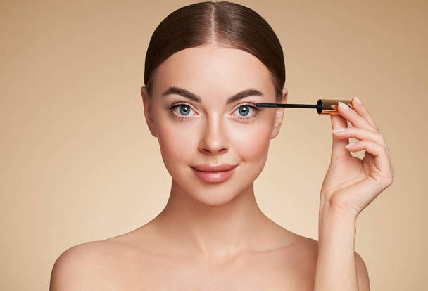 Beauty woman applying black mascara on eyelashes with makeup brush. Eyelash extensions. makeup, cosmetics. Beauty skincare - Photo, Image