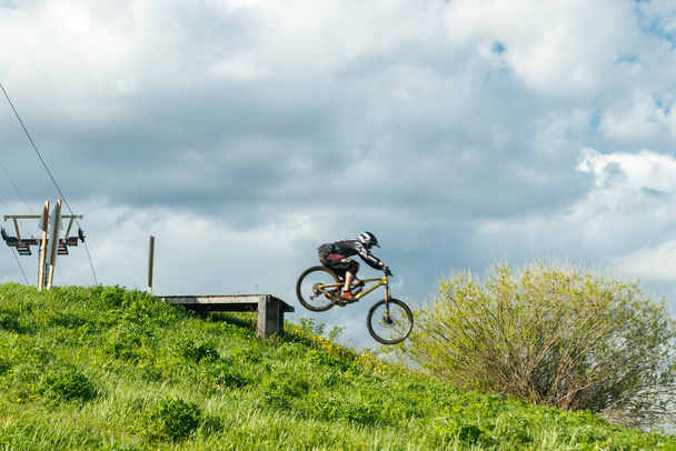 Mountain biker is jumping from the drop - Fotoğraf, Görsel
