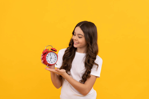 cheerful teen girl look at alarm clock. last chance. time for shopping sales. good morning. daily schedule. childhood. teen girl checking time. do not be late. punctual kid with clock. discipline. - Photo, Image