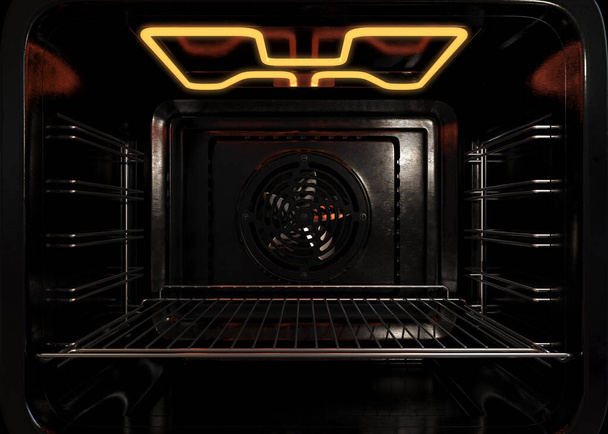 An upclose view of the inside of an empty operational household oven with a glowing element and metal rack - 3D render - Photo, Image