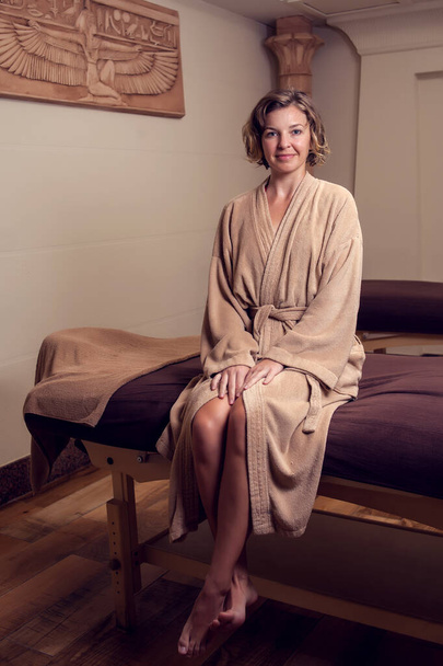 Beautiful young woman relaxing in the spa salon-Spa, beauty, people and body care concept - Photo, image
