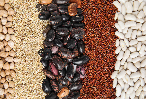 Various raw veggie seeds as background, top view - Foto, Bild