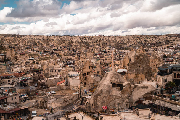Goreme, Turkey - March 21, 2021 - panoramic view of the tourist town of Goreme in Cappadocia, Turkey with fairy chimneys, houses, and unique rock formations - Photo, Image