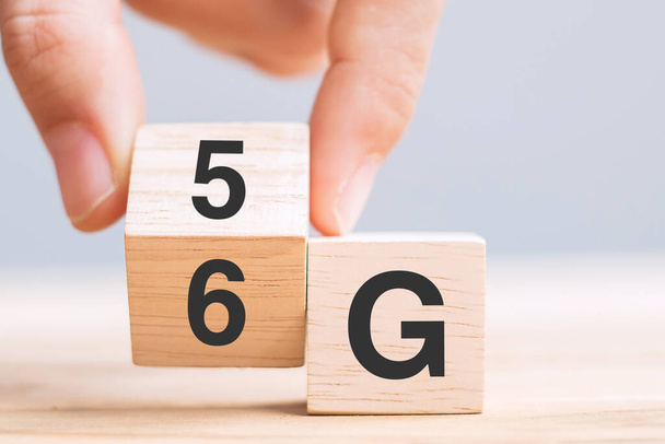 Businessman hand change wooden block from 5G to 6G (Generation of Cellular Mobile Communications) Technology, network, Social media and digital concepts - Photo, Image