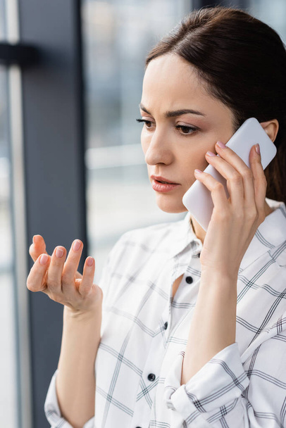 Businesswoman talking on mobile phone in office  - Photo, image