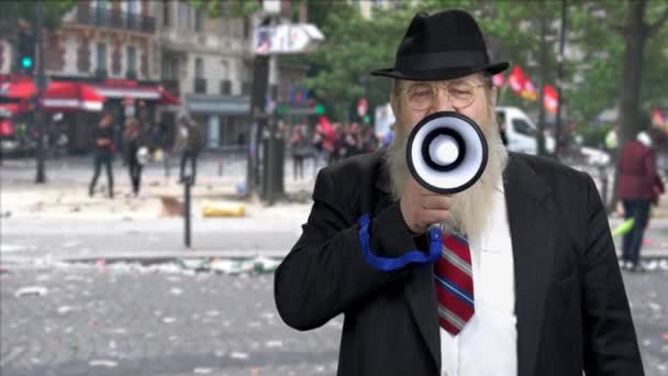 Portrait of serious man in suit speaking through megaphone. - Footage, Video