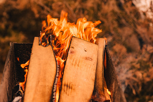bonfire in the grill burning coals for kebab firewood. Firewood burning on grill. Texture fire. - Fotó, kép