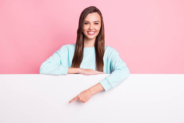 Photo of charming person indicate finger empty space light blue pullover outfit isolated on pink color background - Foto, Imagen