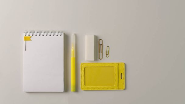 White notebook and stationery yellow on a gray background. Copying space, flat layout - Zdjęcie, obraz