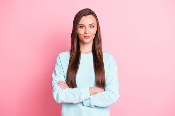 Photo of serious confident young woman folded hands wear blue sweater isolated on pastel pink color background - Фото, зображення
