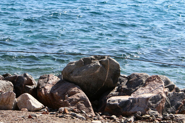 Large stones lie on the shores of the Mediterranean Sea in northern Israel  - Photo, Image