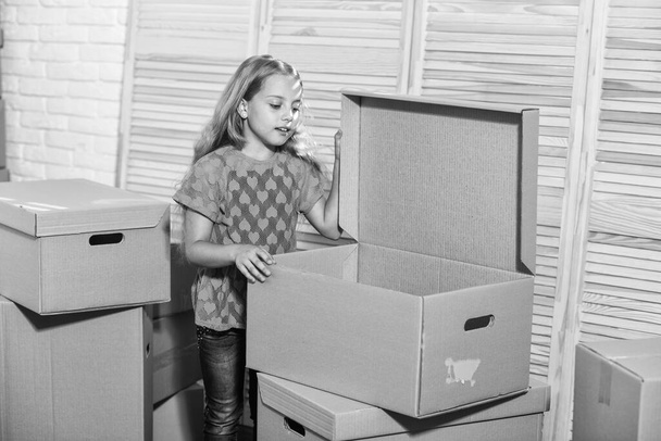 happy little girl. purchase of new habitation. happy child cardboard box. Moving concept. new apartment. Cardboard boxes - moving to new house. Smartly Priced - Zdjęcie, obraz