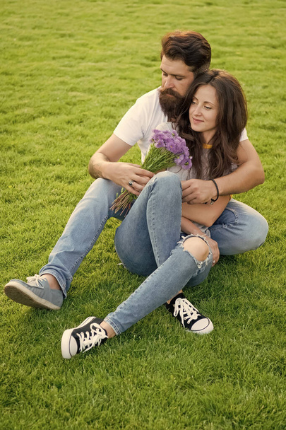 Lovely couple cuddling relaxing on green meadow, womens day concept - Fotografie, Obrázek