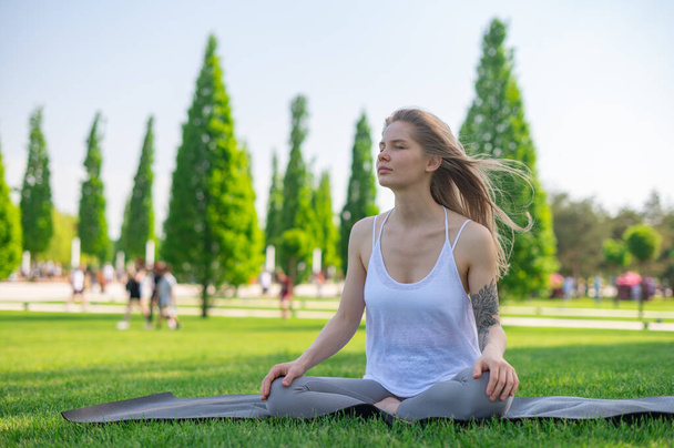 Yoga practice and meditation outdoor. Girl in the park - Photo, Image
