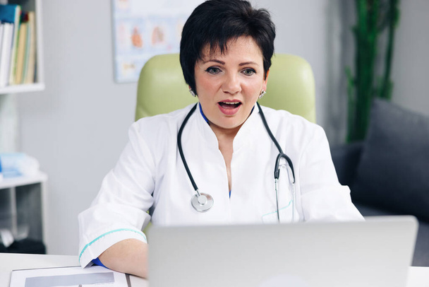 Female doctor make online video call consult patient. Caucasian woman therapist videoconferencing talking to camera in remote chat. Telemedicine, telehealth - Fotografie, Obrázek