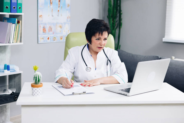 Female doctor talk with patient make telemedicine online webcam video call. Woman therapist videoconferencing on computer in remote telemedicine laptop virtual chat. Telehealth concept. - Fotoğraf, Görsel