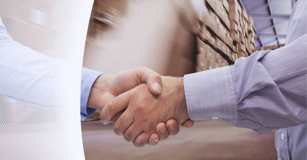 White technology background over mid section of businessmen shaking hands in warehouse. global logistics business and technology concept - Foto, immagini