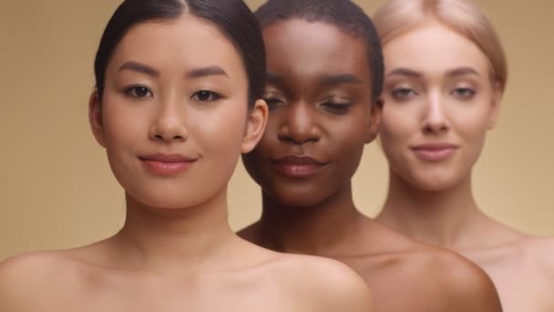 Spa and body care concept. Beauty portrait of three diverse beautiful ladies smiling to camera, standing one by one - Footage, Video