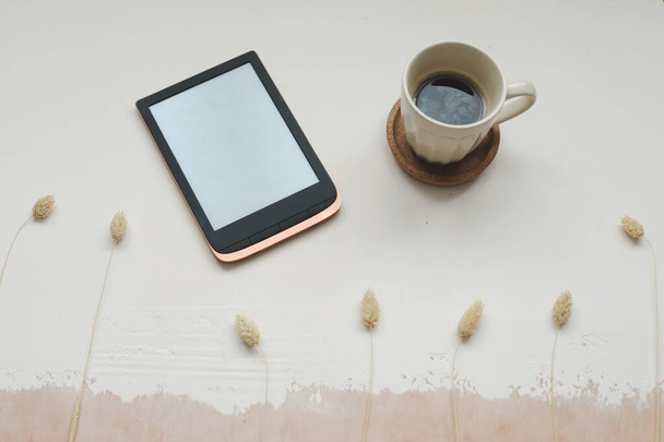 E-book and a cup of coffee on light background - Foto, Bild