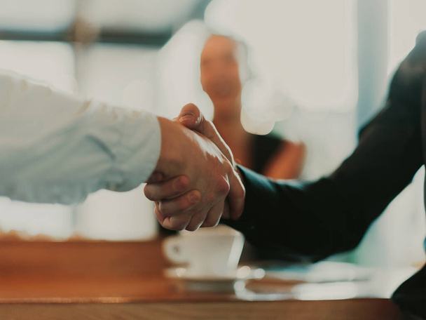 Business people or lawyers shaking hands finishing up meetings or negotiations in sunny offices. Business handshake and partnership - Foto, Bild