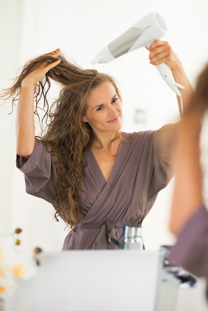 Woman blow drying hair - Foto, Imagen