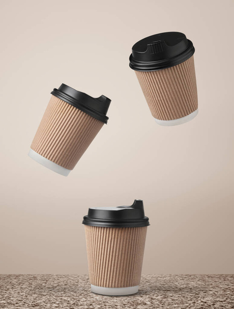 Paper coffee cups flying over marble surface against beige background. - Zdjęcie, obraz