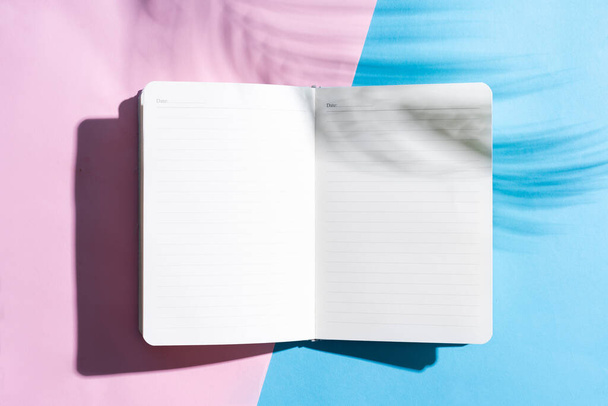 Blank open book on blue and pink background, summer concept - Photo, Image
