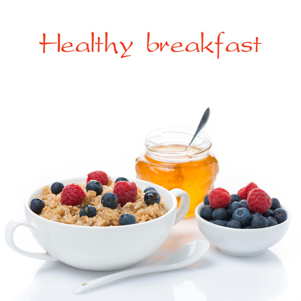 Healthy breakfast - oat porridge with berries, honey, isolated - Фото, изображение