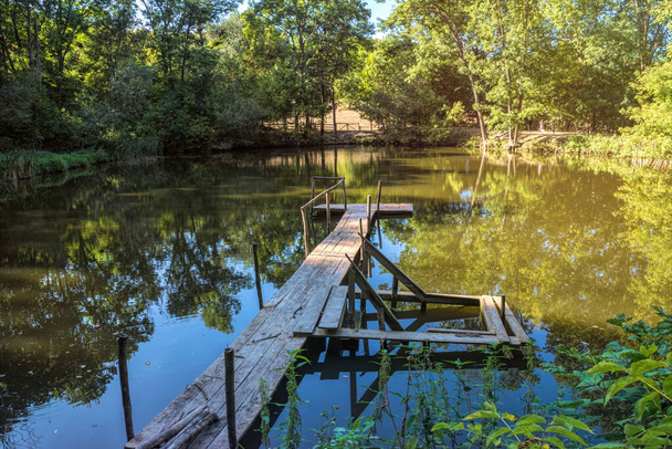Summer forest lake and tarry wooden pier - Photo, Image