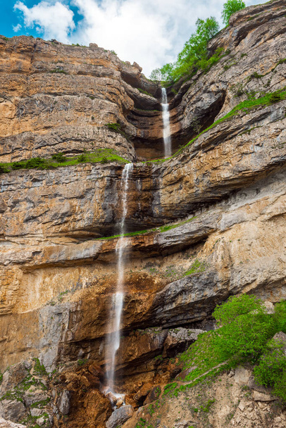 Beautiful high waterfall in the mountains - Photo, image