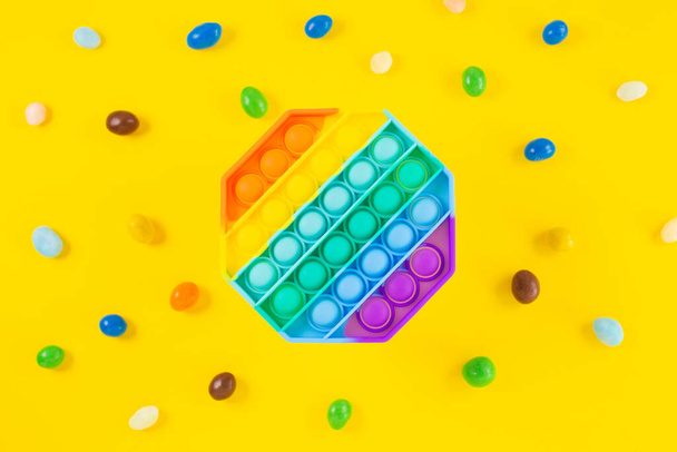 Rainbow silicone sensory Antistress pop it toy around colorfull candy - Φωτογραφία, εικόνα