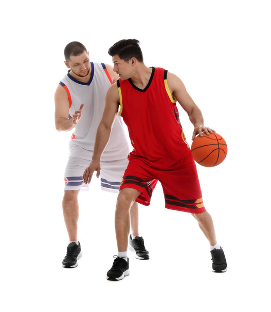 Professional sportsmen playing basketball on white background - Foto, afbeelding