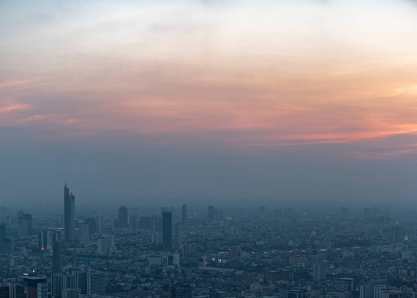 Bangkok city skyline at melacholic lonely misty sunset view from Baiyok ii Tower - Photo, Image