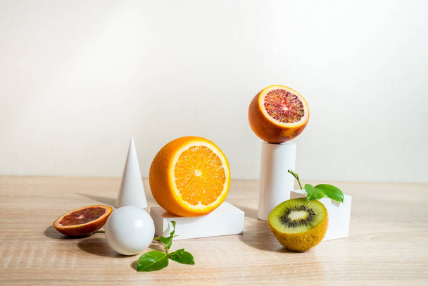 Citrus still life concept with lemon,lime and orange on white stands and podiums over white background, horizontal  - Фото, зображення