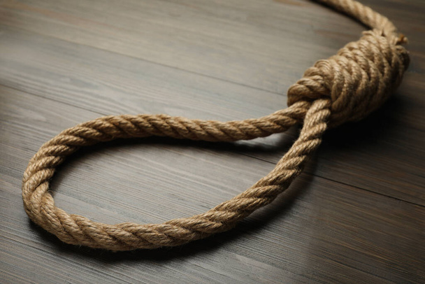 Rope noose on wooden table, closeup view - Fotografie, Obrázek