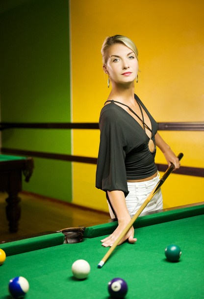 Beautiful blond woman playing billiards - Fotoğraf, Görsel