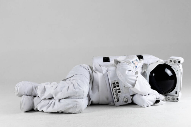 Astronaut lying on side, white background - Foto, Imagem