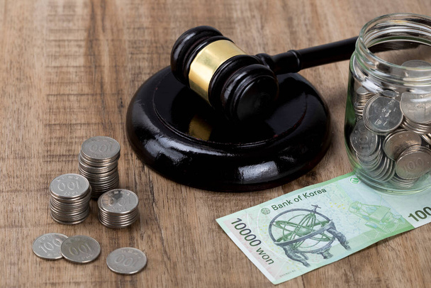 Crime and law - glass bottles filled with coins Banknote and gavel - Foto, imagen