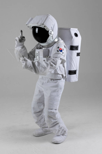 Pointing astronauts Tablet PC with hands, white background - Foto, Bild
