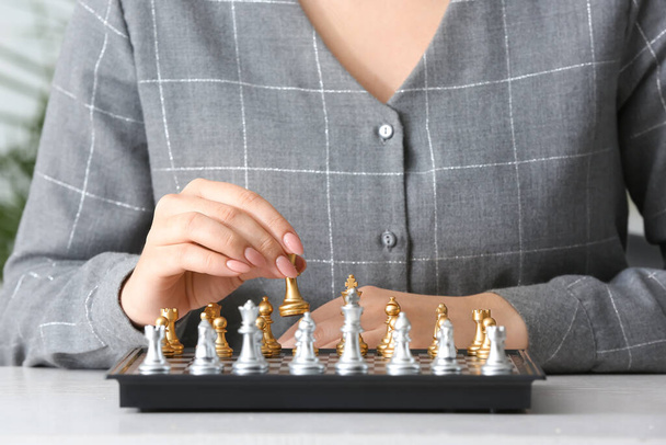 Woman playing chess at table, closeup - Foto, imagen