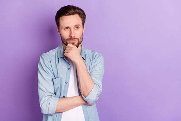 Photo of serious thoughtful minded suspicious man look copyspace thinking isolated on purple color background - Zdjęcie, obraz