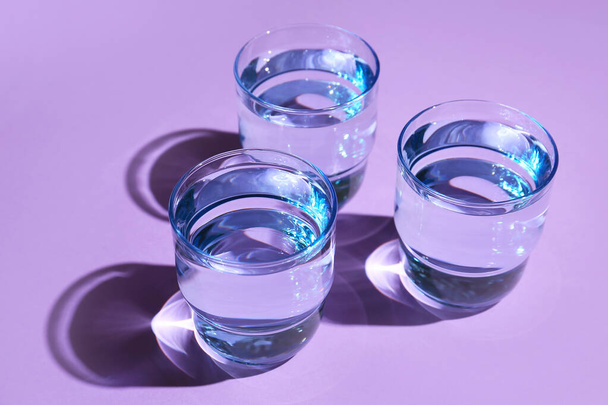 Glasses of water on color background, closeup - Фото, изображение