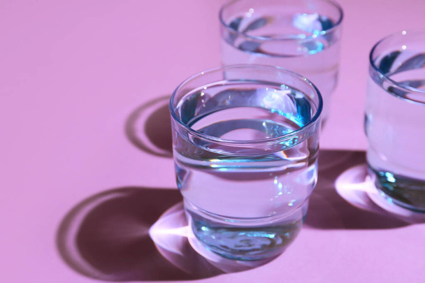 Glasses of water on color background - Фото, изображение