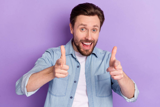 Photo of clever funky young guy wear denim clothes open mouth pointing fingers you isolated purple color background - Fotó, kép