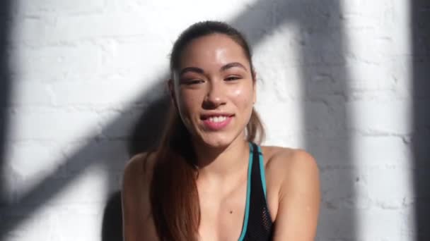 Portrait of beautiful woman. Happy fit girl in sportswear laughing - Footage, Video