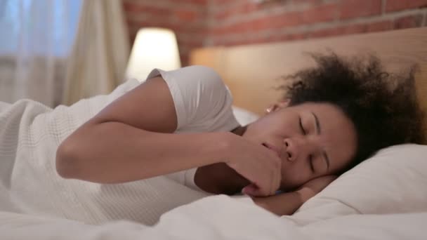 アフリカ人女性がベッドで寝ながら咳をする - 映像、動画